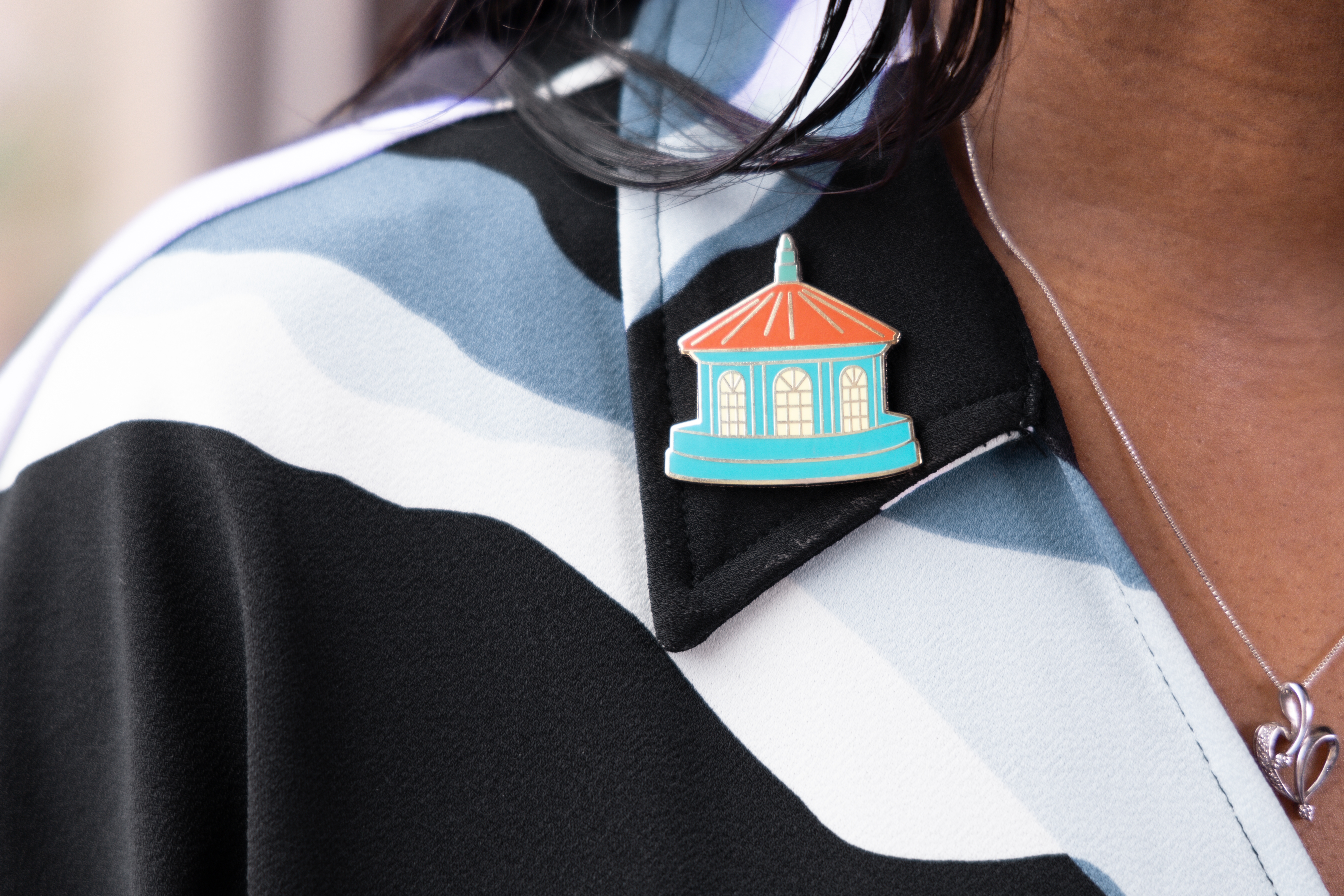 A colorful enamel pin featuring the Silent Unity cupola